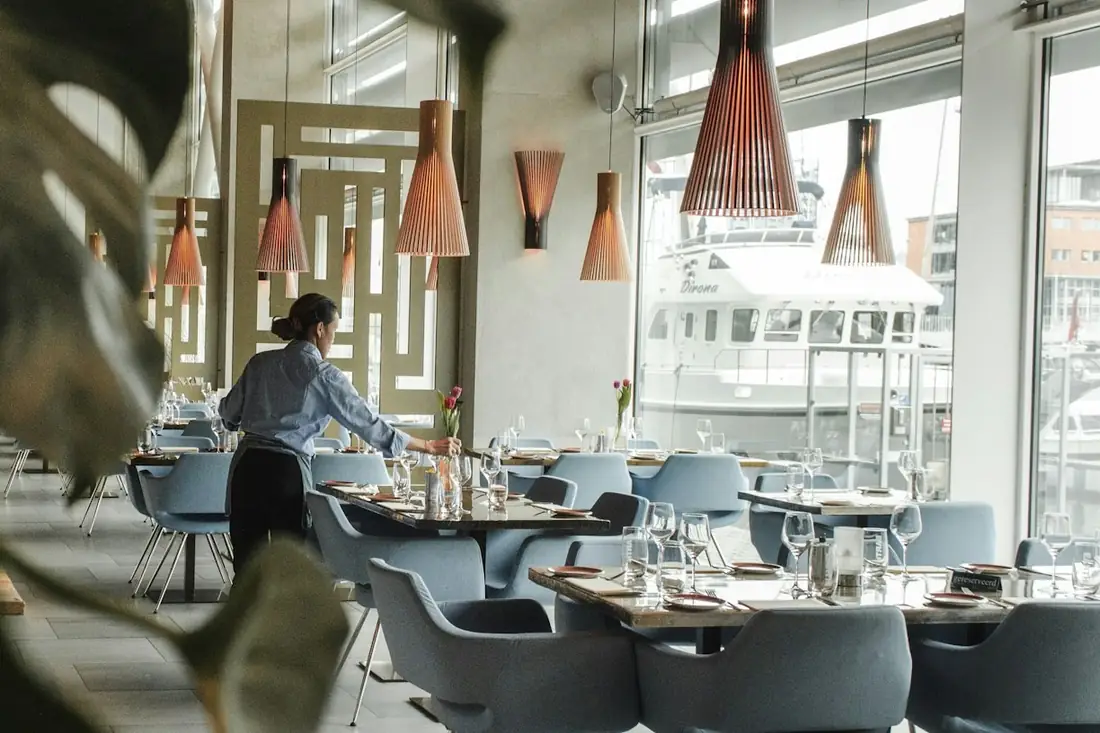 Restaurant dining room being set before service